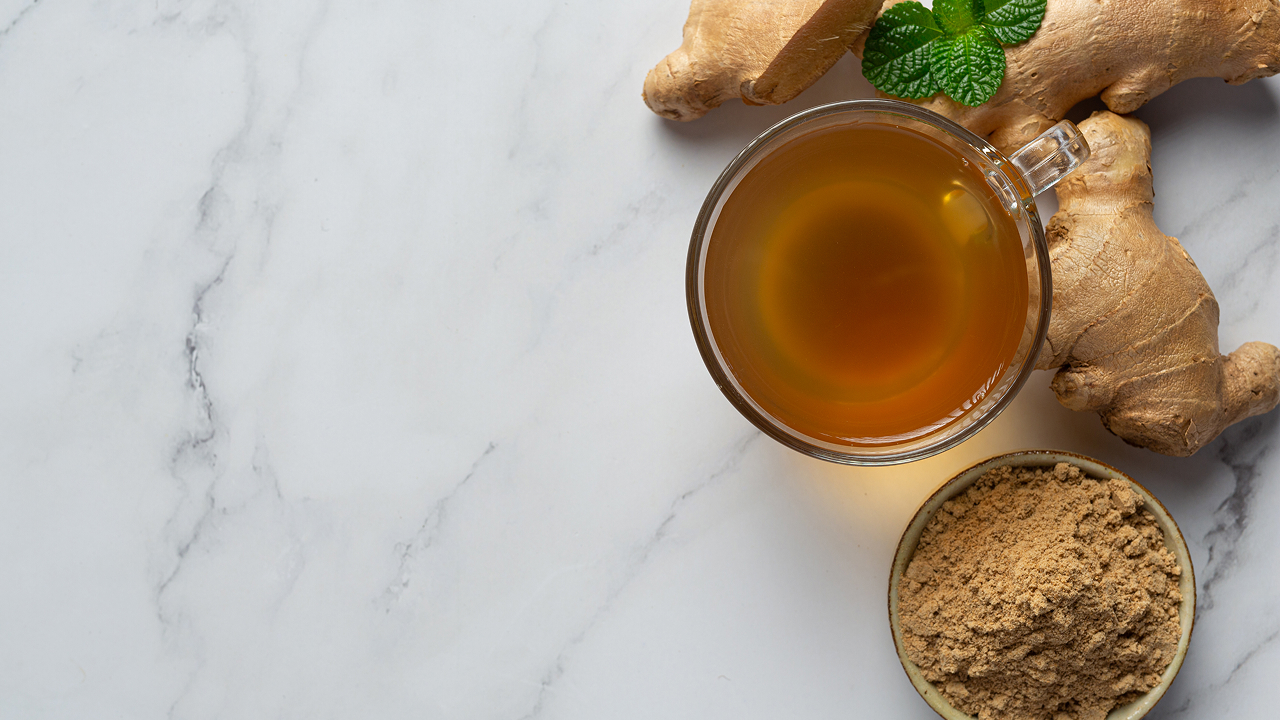 A cup of hot ginger tea on a table