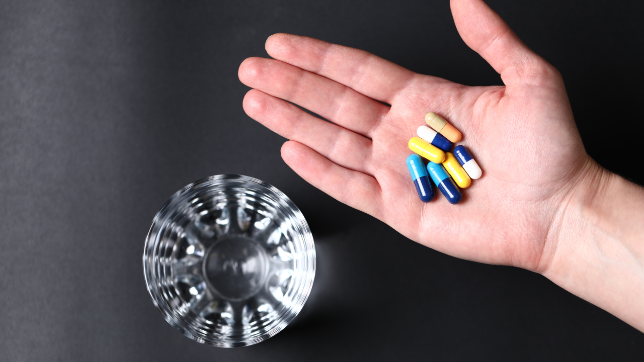 Colorful medical pills in a person's hand